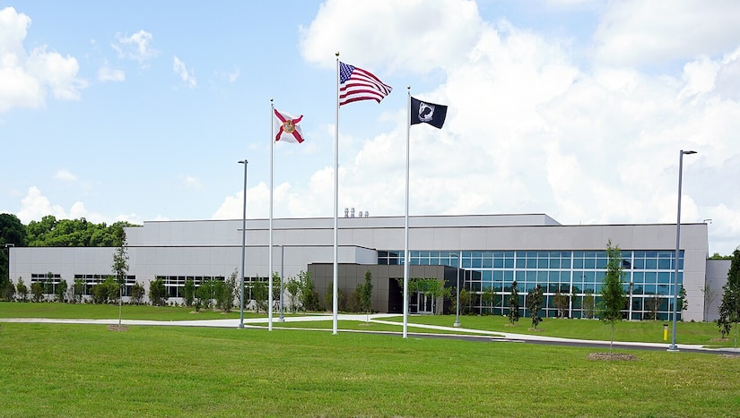 A building with three flags in front of it
