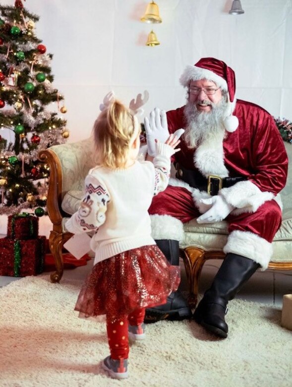 David Quebedeaux, a park ranger at J. Strom Thurmond Lake with the U.S. Army Corps of Engineers, Savannah District, high-fives a little girl at a Santa meet-and-greet event. Quebedeaux’s appearances as Santa in previous years included local television stations, civic organizations and a special project called Sensory Santa geared toward children with special needs.