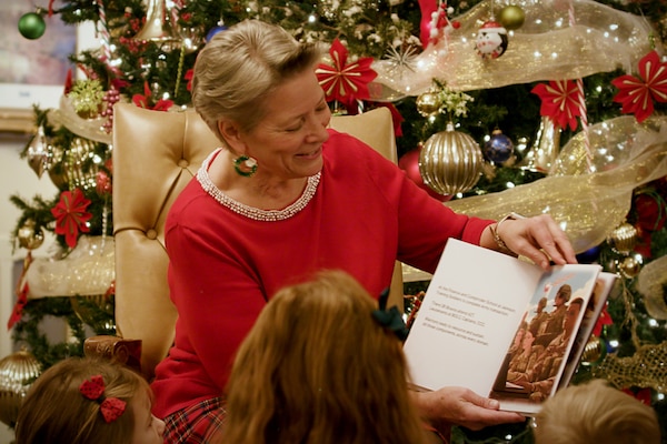 Caral Spangler, Assistant Secretary of the Army for Financial Management and Comptroller, reads a special holiday poem focused on the Army Finance Corps to three children from the U.S. Army Futures Command in Austin, Texas, Nov. 30, 2023. For the last several years, the Office of the ASA (FM&C), the U.S. Army Financial Management Command, and the U.S. Army Finance and Comptroller School partnered together to create a special holiday video for U.S. Army Soldiers, civilian employees and their families. (U.S. Army photo by Mark R. W. Orders-Woempner)