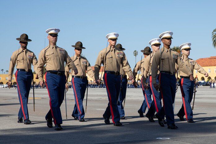 U.S. Marine Corps staff and drill instructors with Kilo Company, 3rd Recruit Training Battalion, march in formation during a graduation ceremony at Marine Corps Recruit Depot San Diego, Dec. 1, 2023. Graduation took place at the completion of the 13-week transformation, which included training for drill, marksmanship, basic combat skills, and Marine Corps customs and traditions. (U.S. Marine Corps photo by Lance Cpl. Sarah M. Grawcock)