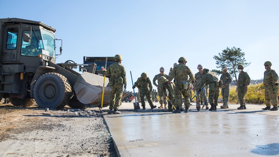 U.S. Marines with Marine Wing Support Squadron 171, Sailors with Naval Mobile Construction Battalion 3, and Japan Ground Self-Defense Force service members with Amami Area Security Forces conduct airfield damage repair training during the field training exercise portion of Resolute Dragon 23 at JGSDF Kirishima Training Area, Japan, Oct. 25, 2023. RD 23 is an annual bilateral exercise in Japan that strengthens the command, control, and multi-domain maneuver capabilities of Marines in III Marine Expeditionary Force and allied Japan Self-Defense Force personnel. (U.S. Marine Corps photo by Cpl. Chloe Johnson)