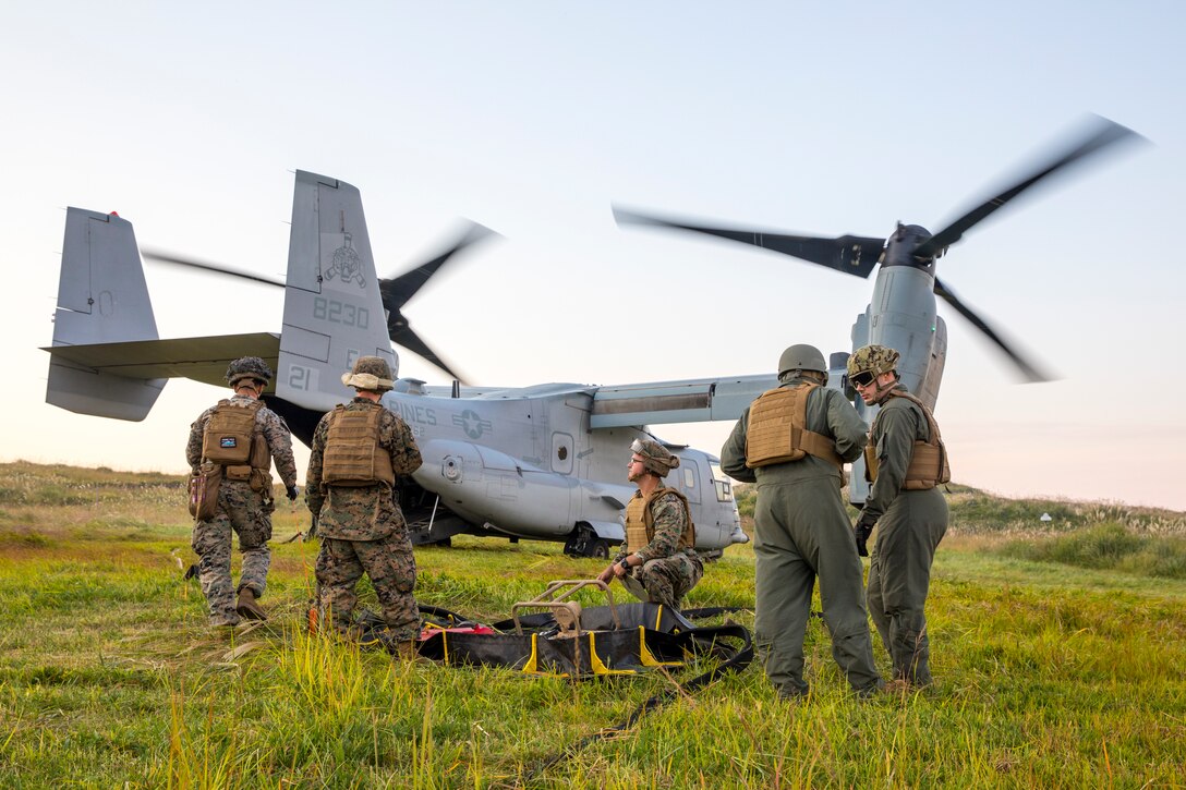 U.S. Marines with Marine Wing Support Squadron (MWSS) 171, Marine Aircraft Group (MAG) 12, 1st Marine Aircraft Wing, and Sailors with Navy Cargo Handling Battalion 1, Task Force 75, Naval Expeditionary Forces Command Pacific, conduct a forward arming refueling point with Marine Medium Tiltrotor Squadron (VMM) 262, MAG-36, 1st MAW, while participating in the field training exercise portion of Resolute Dragon 23 at Japan Ground Self-Defense Force Camp Jumonjibaru, Oita Prefecture, Japan, Oct. 19, 2023. RD 23 is an annual bilateral exercise in Japan that strengthens the command, control, and multi-domain maneuver capabilities of Marines in III Marine Expeditionary Force and allied Japan Self-Defense Force personnel. (U.S. Marine Corps photo by Cpl. Chloe Johnson)