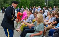 Laura Coppola accepts flowers at the ceremony to dedicate a conference room in honor of her late husband, Fred Coppola, 4 Aug. 2023 at Picatinny Arsenal, NJ.