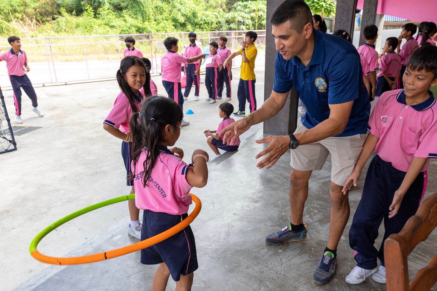 Navy Lt. Jamil A. Khan, right, chaplain, MSC Far East in Singapore, interacts with a child during a community relations event at the Learning Center of the Human Help Network in Pattaya, Thailand, Dec. 4. (Photo by Grady T. Fontana)