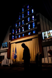 Col. Julian Gaither, Air Force Global Strike Command Command chaplain, bows his head in prayer during an Assumption of the Stole Ceremony at Minot Air Force, North Dakota, Nov. 30, 2023. The assumption of the Stole reminds all chaplains and religious affairs specialists of their calling to serve Soldiers and Families as servant-leaders. (U.S. Air Force photo by Airman 1st Class Alexander Nottingham)