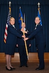 Col. Michelle Van Sickle, 433rd Medical Group commander, presents the 433rd Aeromedical Staging Squadron guidon to Lt. Col. Angella Mudd during an assumption of command ceremony on Joint Base San Antonio-Lackland, Texas, Dec. 2, 2023.