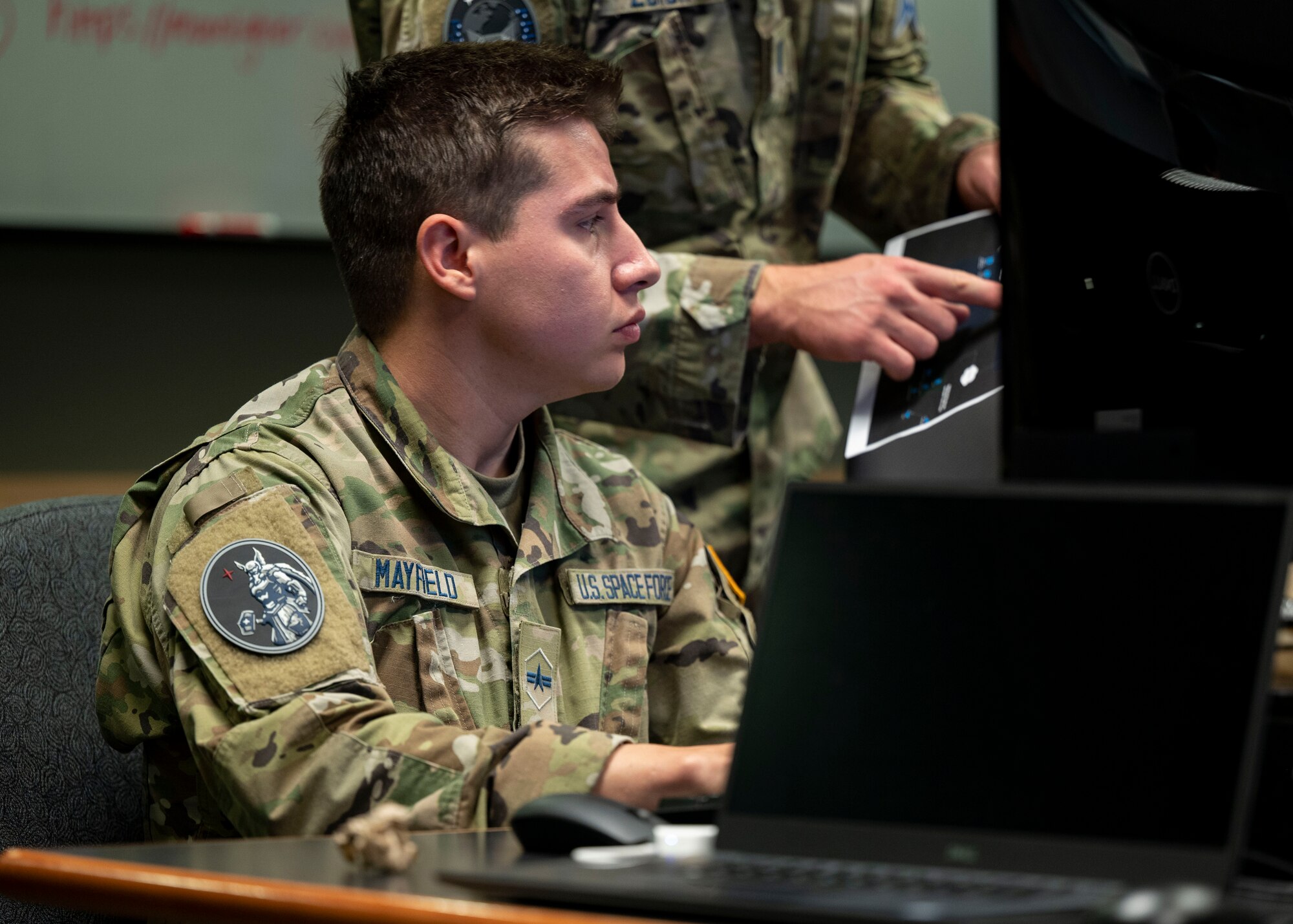 A U.S. Space Force Guardian participates in Moonlighter, an exercise designed to focus on refining the defensive and offensive skill sets of Cyber Guardians, centered around the Moonlighter imaging satellite, in Colorado Springs, Colorado, Nov. 15, 2023, The Moonlighter imaging satellite, a 3U CubeSat, serves as an exclusive on-orbit cyber test platform. Its role includes facilitating defensive cyber operations and refining cyber-related tactics, techniques, and procedures.(U.S. Air Force photo by 1st Lt. Charles Rivezzo)