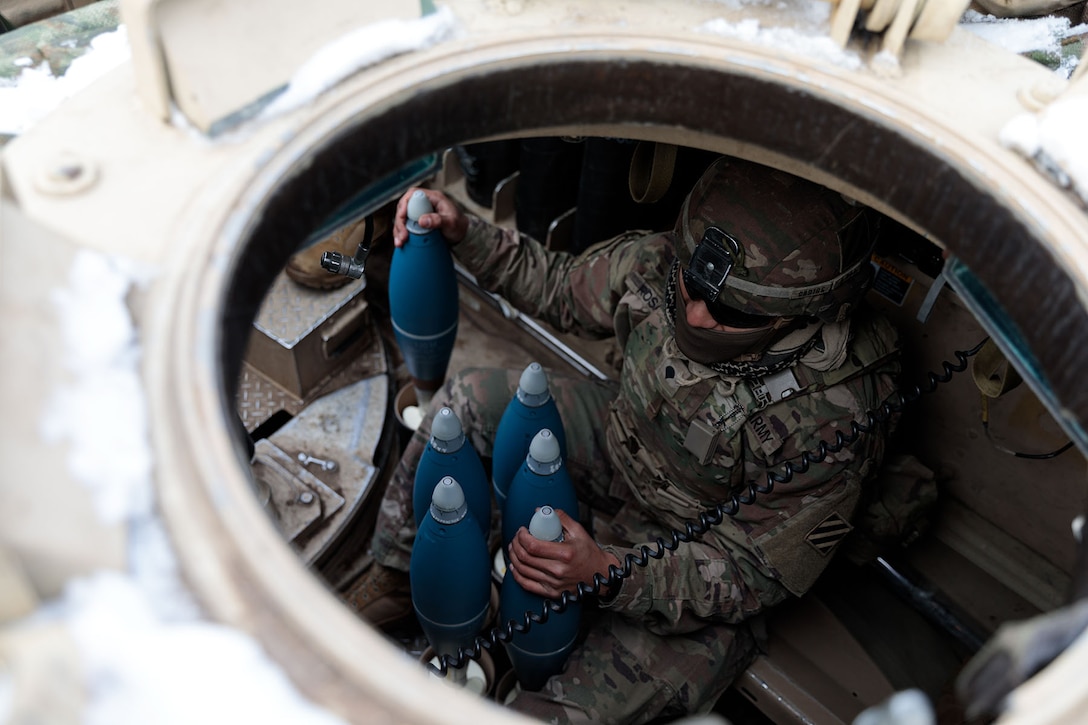 A soldier prepares full-range training mortar rounds during a training mission.