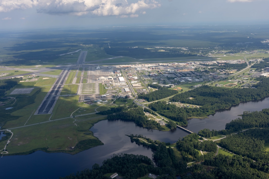 An aerial photo of Marine Corps Air Station (MCAS) Cherry Point, taken from a KC-130J Super Hercules assigned to Marine Aerial Refueler Transport Squadron 252, 2nd Marine Aircraft Wing, during a close formation flying exercise at MCAS Cherry Point, North Carolina, July 11, 2023. Historical aerial photographs of MCAS Cherry Point are captured to showcase the development and expansion of the installation over the years. (U.S. Marine Corps photo by Cpl. Jade Farrington)