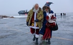 Santa and Mrs. Claus disembark from a C-17 Globemaster III and head to a UH-60 Black Hawk helicopter to support Operation Santa Claus at Bethel, Alaska, Nov. 15, 2023. Operation Santa Claus is the AKNG’s yearly community outreach program that provides gifts and Christmas cheer to children in remote communities.