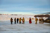 Santa and fellow Operation Santa Claus volunteers greet community members as they exit an Alaska Army National Guard UH-60L Black Hawk near the Inupiat Eskimo village of Golovin Nov. 30, 2023. Operation Santa Claus is the Alaska National Guard’s annual community outreach program that provides gifts and Christmas cheer to children in remote communities.