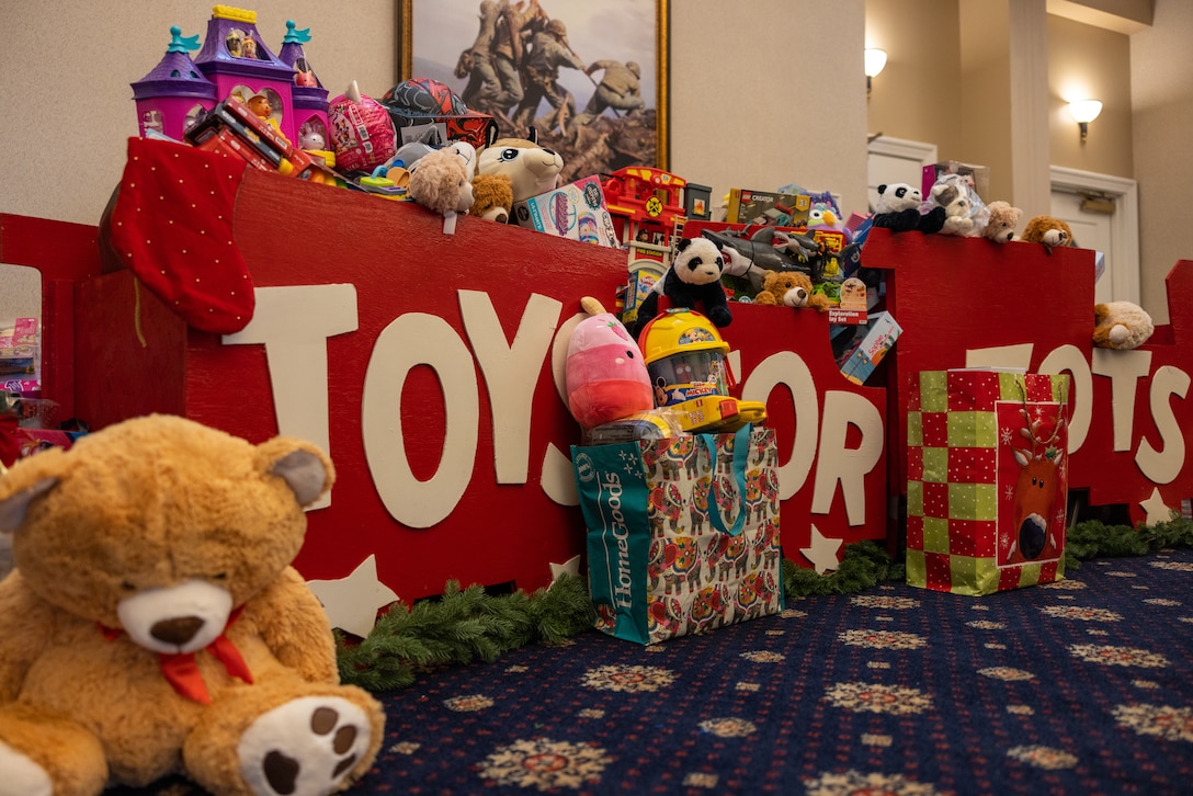 A collection of toys sit on a table during the Toys for Tots Luncheon and Toy Collection Event hosted by the Quantico Spouses’ Social Club at The Clubs at Quantico on Marine Corps Base Quantico, Virginia, Nov. 13, 2023. The basic mission of the Marine Toys for Tots Program is to collect new unwrapped toys and distribute those toys to less fortunate children at Christmas.