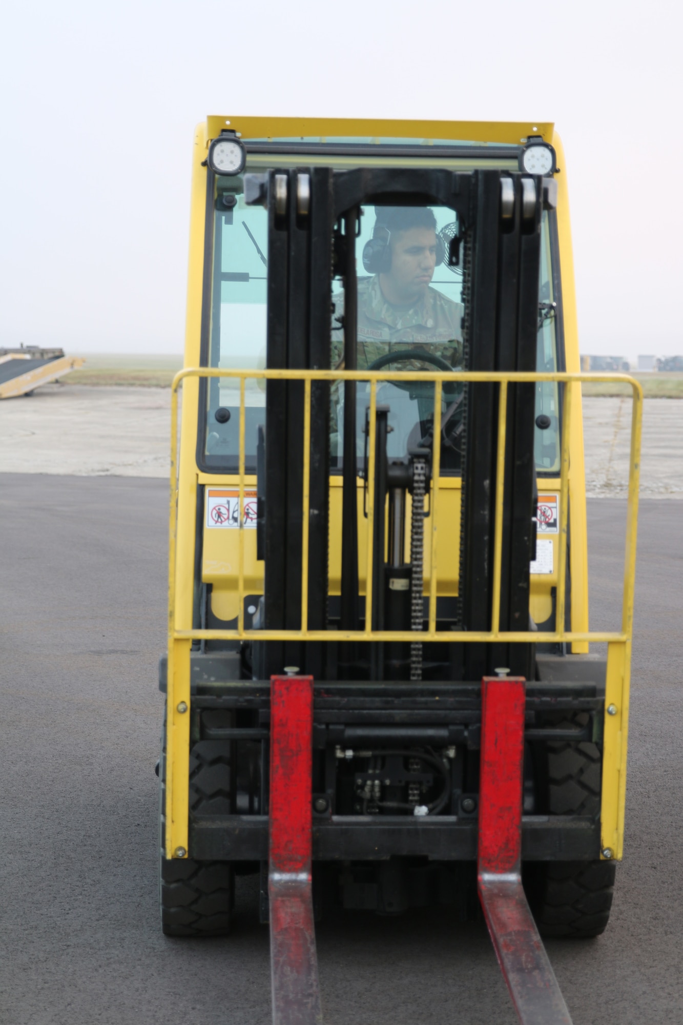 Senior Airman David Delarosa, ramp services specialist, 87th Aerial Port Squadron, drives a 4K forklift adjacent to the flightline at Wright-Patterson Air Force Base, Ohio, Nov. 5, 2023 so that it can be inspected and serviced along with other material handling equipment. Forklifts like these are typically used inside the aerial port’s cargo warehouse to move skids of cargo and position them onto pallets in preparation of military airlift.