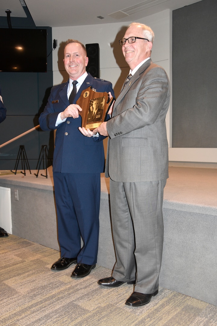 Brig. Gen. David May, Wisconsin’s deputy adjutant general for Air, presents retired Brig. Gen. Gary Ebben with a plaque during a Wisconsin Air National Guard Hall of Fame induction ceremony Dec. 1 at Joint Force Headquarters in Madison, Wis. Ebben served as Wisconsin’s interim adjutant general as well as deputy adjutant general for Air, and prior to that commanded Volk Field Combat Readiness Training Center. As a command pilot, he logged more than 3,000 flight hours in such aircraft as the T-41, T-37, T-38, A-10 and RC-26B. Wisconsin Department of Military Affairs photo by Vaughn R. Larson