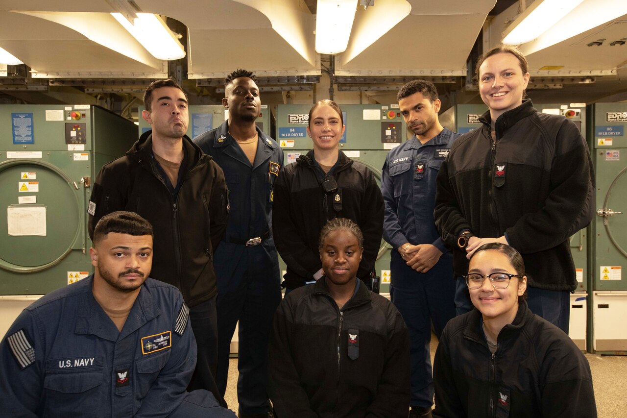 Eight sailors pose for a picture.