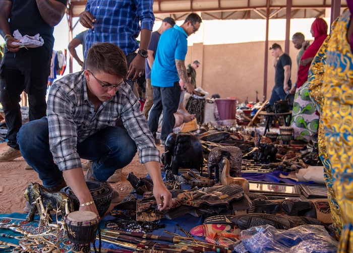 A member looks over items for sale at a Women's Bazaar.