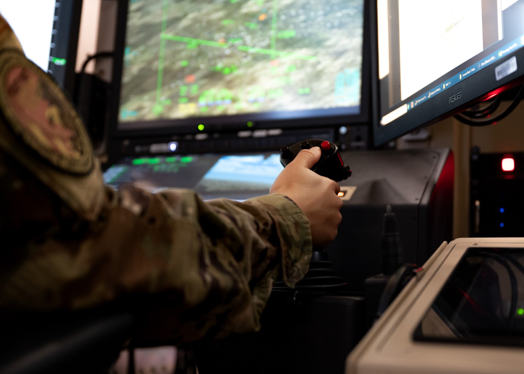 A cadet holds a flight simulator trigger