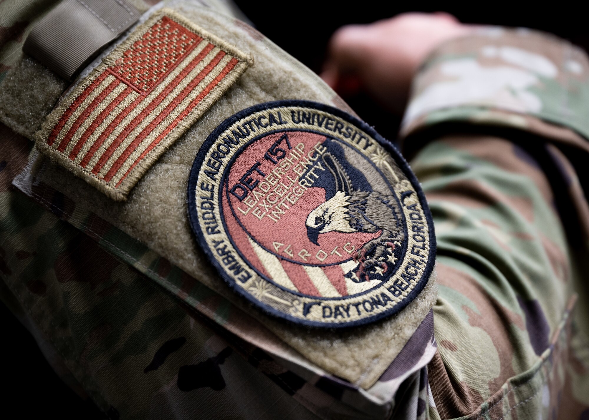 An Air Force patch is displayed on the arm of an Airman