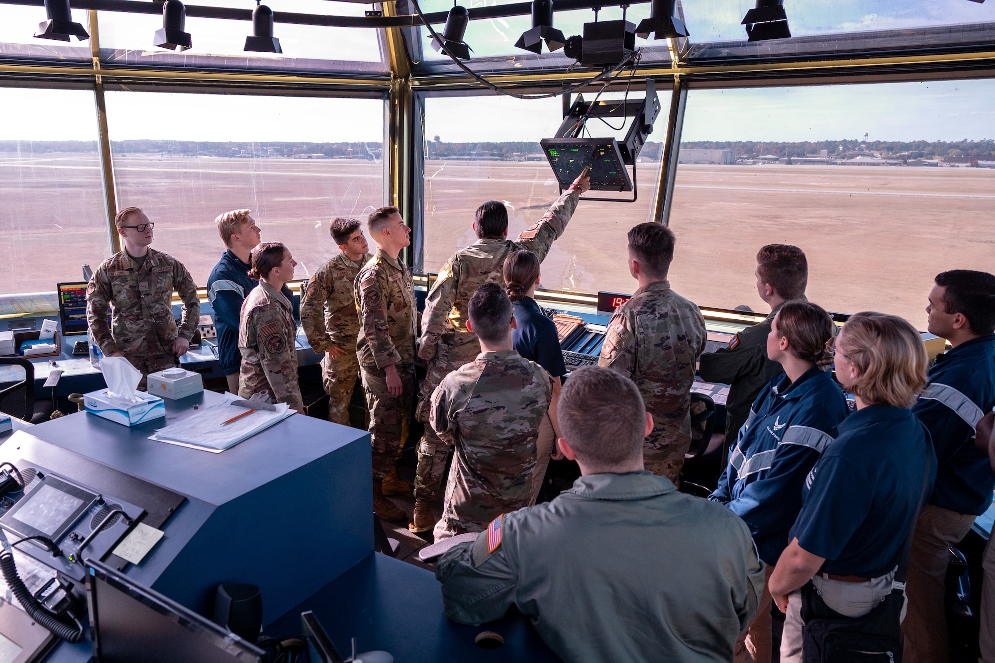 Group of people look outside of an Air Traffic Control tower