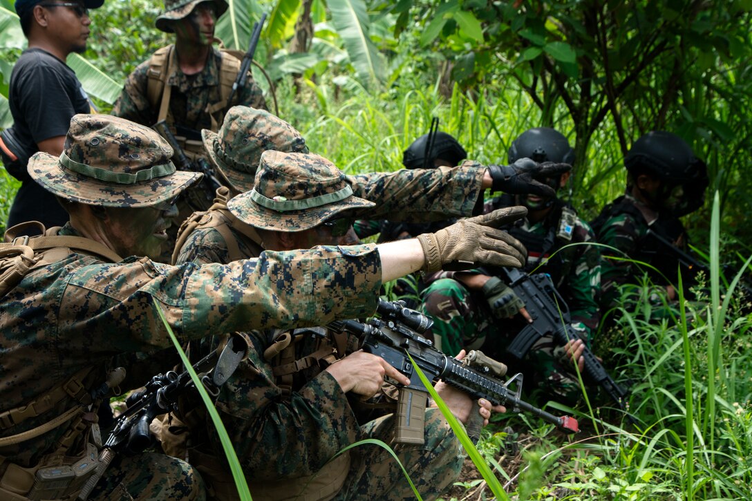 U.S. Marines with 1st Battalion, 7th Marine Regiment, attached to Marine Rotational Force-Southeast Asia, and Indonesian marines with 4th Marine Brigade, Pasmar 1, prepare to conduct a raid during Keris Marine Exercise 2023 at Piabung Training Area, Sukabumi, West Java, Indonesia, Dec. 3, 2023. Keris MAREX is a bilateral exercise led by the U.S. Marine Corps and Indonesia Marine Corps to promote military interoperability and maritime domain awareness capabilities, strengthen relationships, and expand military capabilities among participating forces. MRF-SEA is a Marine Corps Forces Pacific operational model that involves exchanges with subject matter experts, promotes security goals with Allies and partners, and positions I MEF forces west of the International Date Line. (U.S. Marine Corps photo by Sgt. Ryan H. Pulliam)