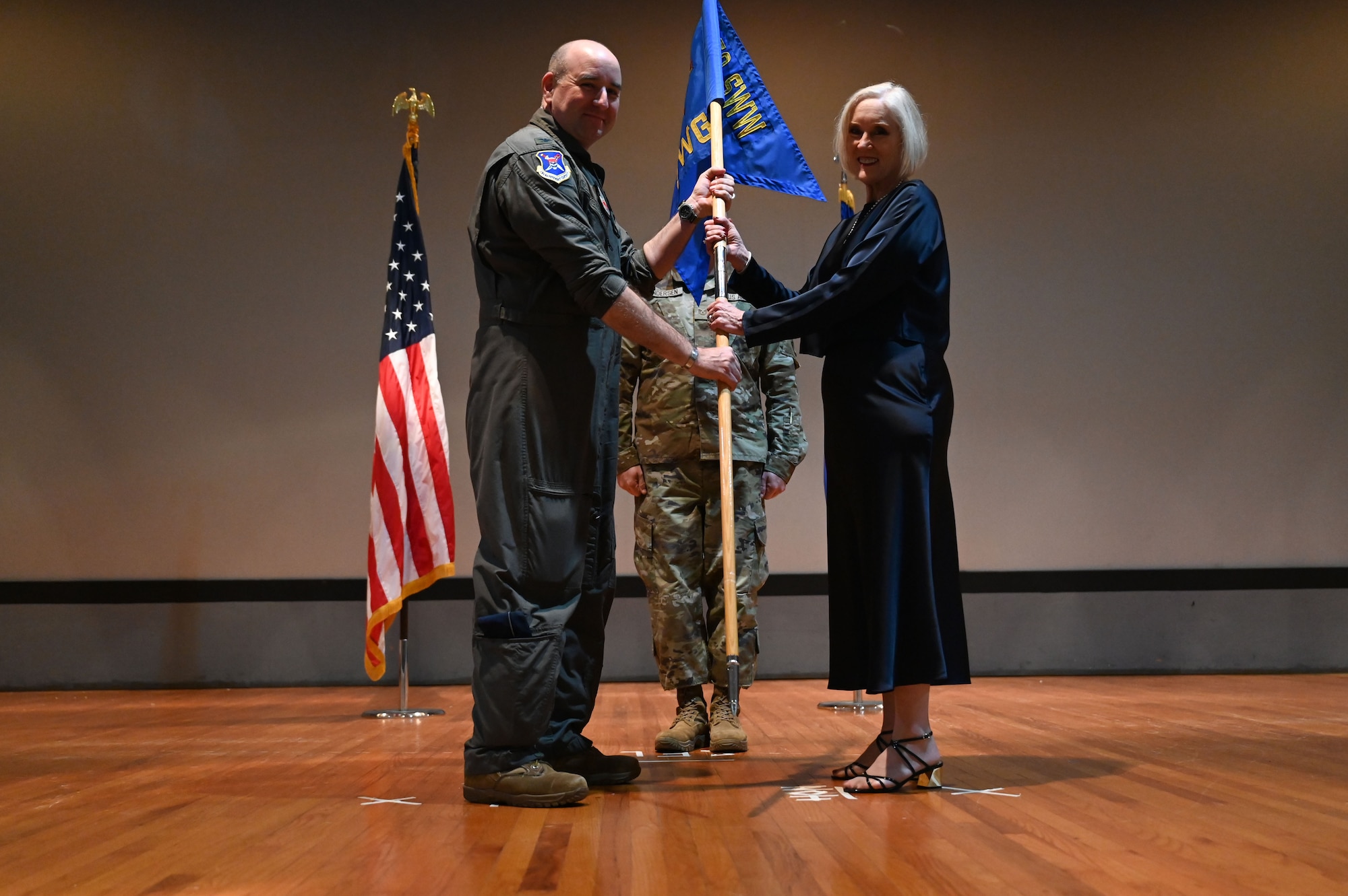 U.S. Air Force Col. Mike Cocke, 350th Spectrum Warfare Group commander, inducts Mitzi Henley, president and CEO of Wright Shopping Center, president and CEO of Sunset Property Development Inc., and member of the Emerald Coast Military Affairs Committee, during the wing’s first Honorary Commander Induction ceremony, at Eglin Air Force Base, Fla., Dec. 1, 2023. Honorary Commanders serve as the liaison between the 350th Spectrum Warfare Wing and the surrounding community by maintaining strong relations through mutually beneficial professional partnership. (U.S. Air Force photo by Staff Sgt. Ericka A. Woolever)