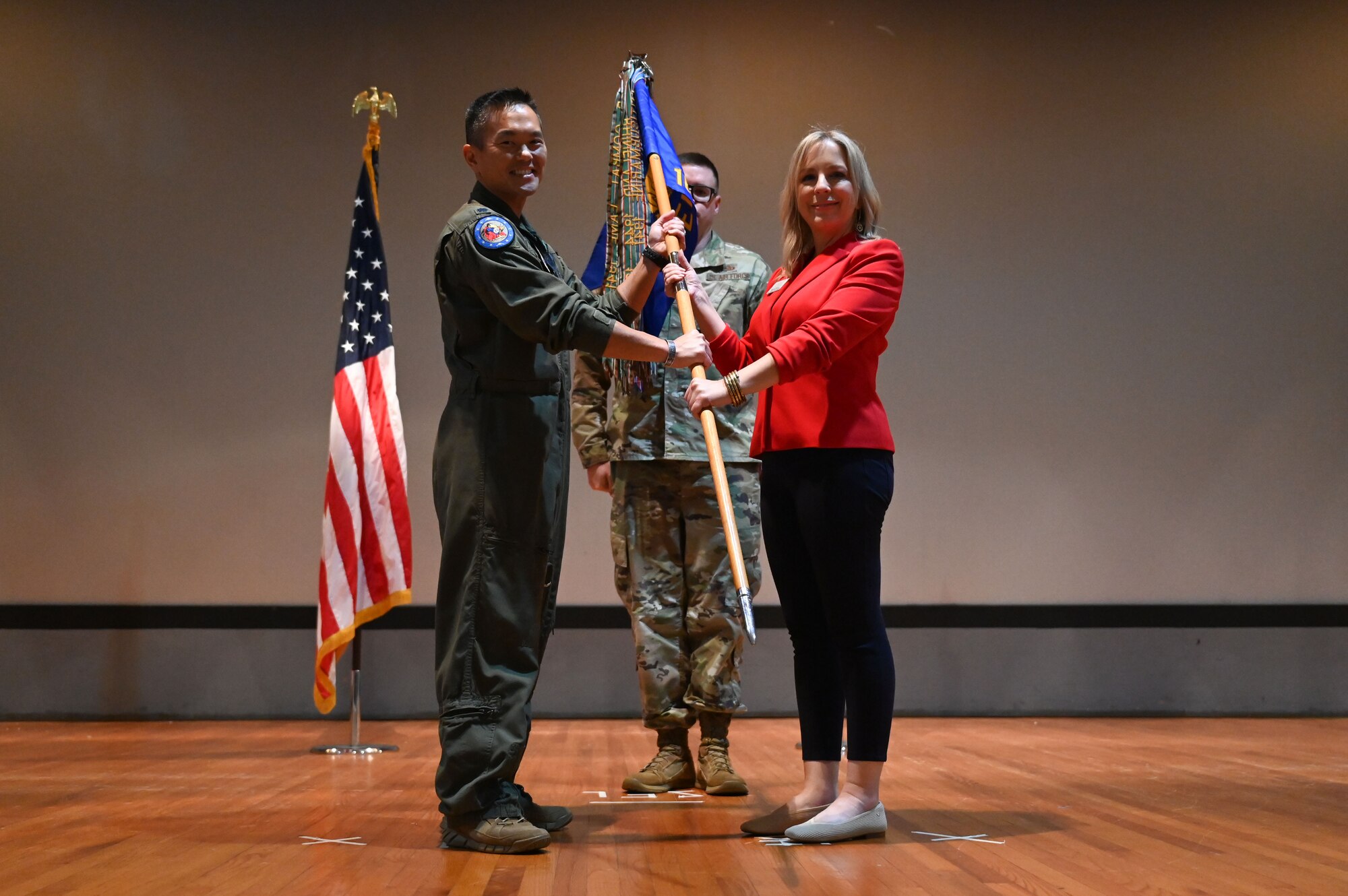 U.S. Air Force Lt. Col. Chad Nishizuka, 16th Electronic Warfare Squadron commander, inducts Melanie Moore, director of education and community engagement for the Mattie Kelly Arts Foundation, during the wing’s first Honorary Commander Induction ceremony, at Eglin Air Force Base, Fla., Dec. 1, 2023. Honorary Commanders serve as the liaison between the 350th Spectrum Warfare Wing and the surrounding community by maintaining strong relations through mutually beneficial professional partnership. (U.S. Air Force photo by Staff Sgt. Ericka A. Woolever)