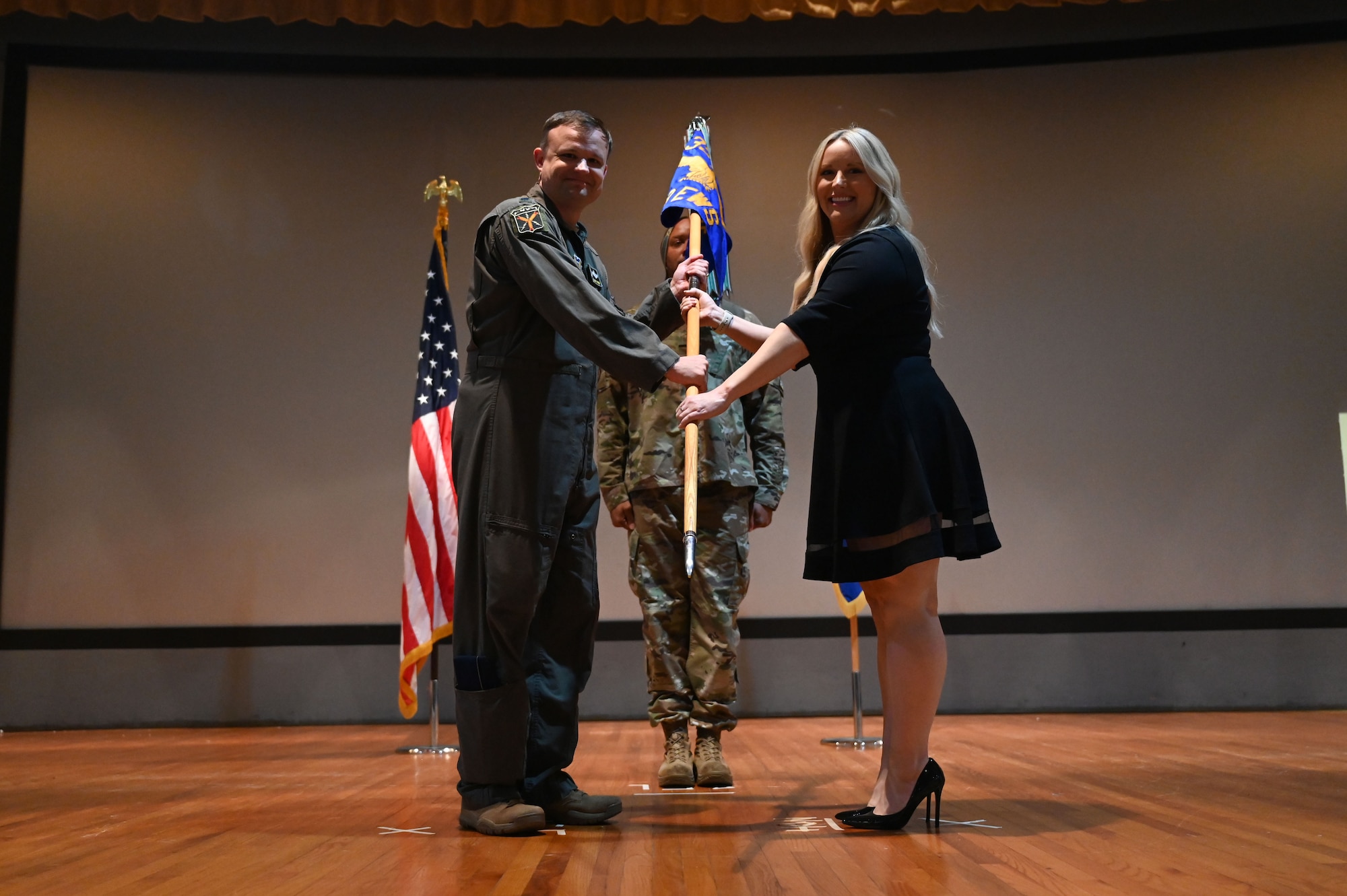 U.S. Air Force Lt. Col. Darren Woodside, 513th Electronic Warfare Squadron commander, inducts Katie Robison, director of sales for Liveoak Fiber, daughter of two Air Force veterans and member on the Greater Fort Walton Beach Chamber of Commerce, during the wing’s first Honorary Commander Induction ceremony, at Eglin Air Force Base, Fla., Dec. 1, 2023. Honorary Commanders serve as the liaison between the 350th Spectrum Warfare Wing and the surrounding community by maintaining strong relations through mutually beneficial professional partnership. (U.S. Air Force photo by Staff Sgt. Ericka A. Woolever)