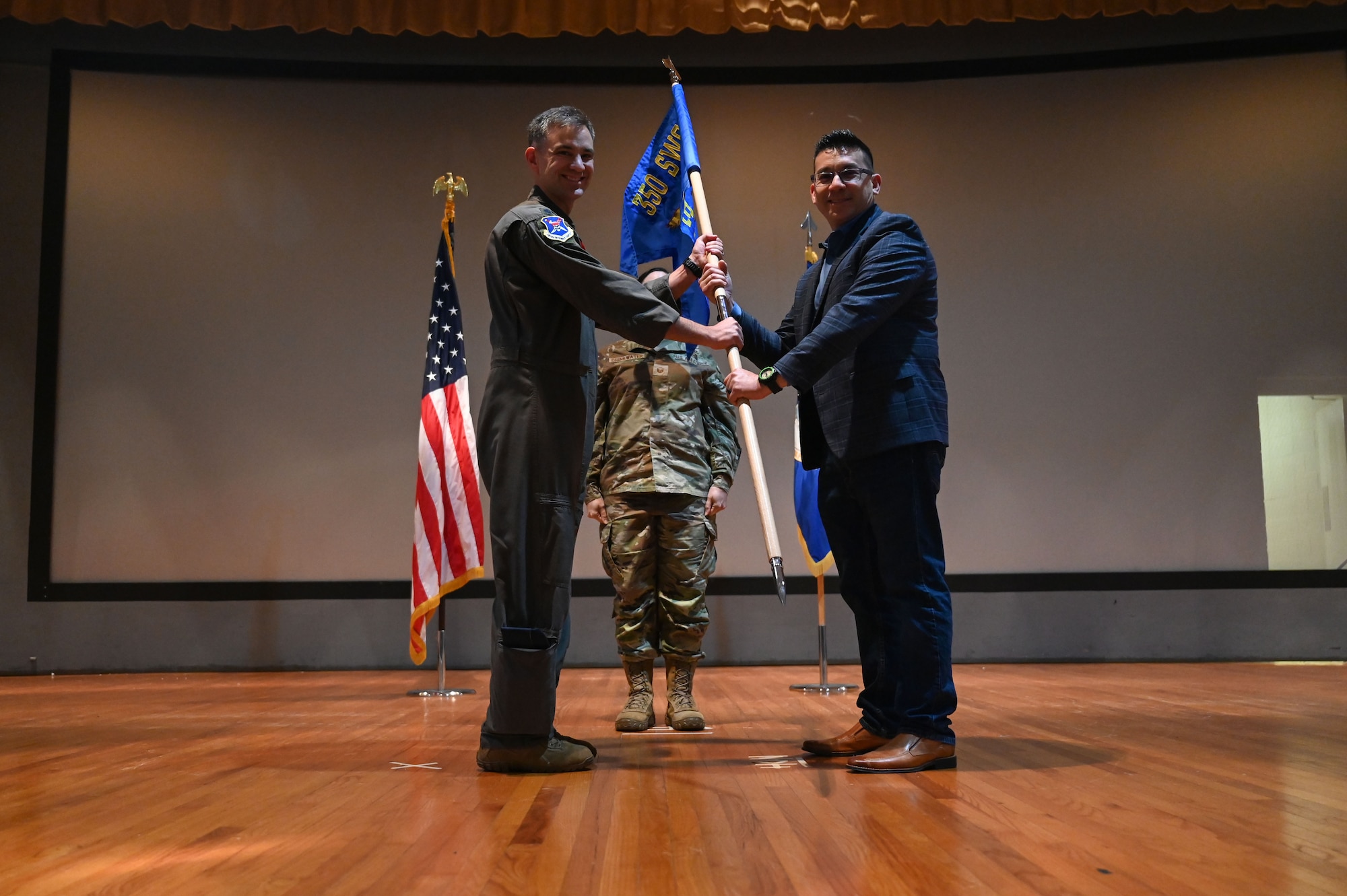 U.S. Air Force Lt. Col. Luke Marron, 350th Spectrum Warfare Group, Detachment 1, commander, inducts Brian Squire, the Executive Vice President at Hays Companies and Brown and Brown Insurance and serves on the Destin Chamber of Commerce, during the wing’s first Honorary Commander Induction ceremony, at Eglin Air Force Base, Fla., Dec. 1, 2023. Honorary Commanders serve as the liaison between the 350th Spectrum Warfare Wing and the surrounding community by maintaining strong relations through mutually beneficial professional partnership. (U.S. Air Force photo by Staff Sgt. Ericka A. Woolever)