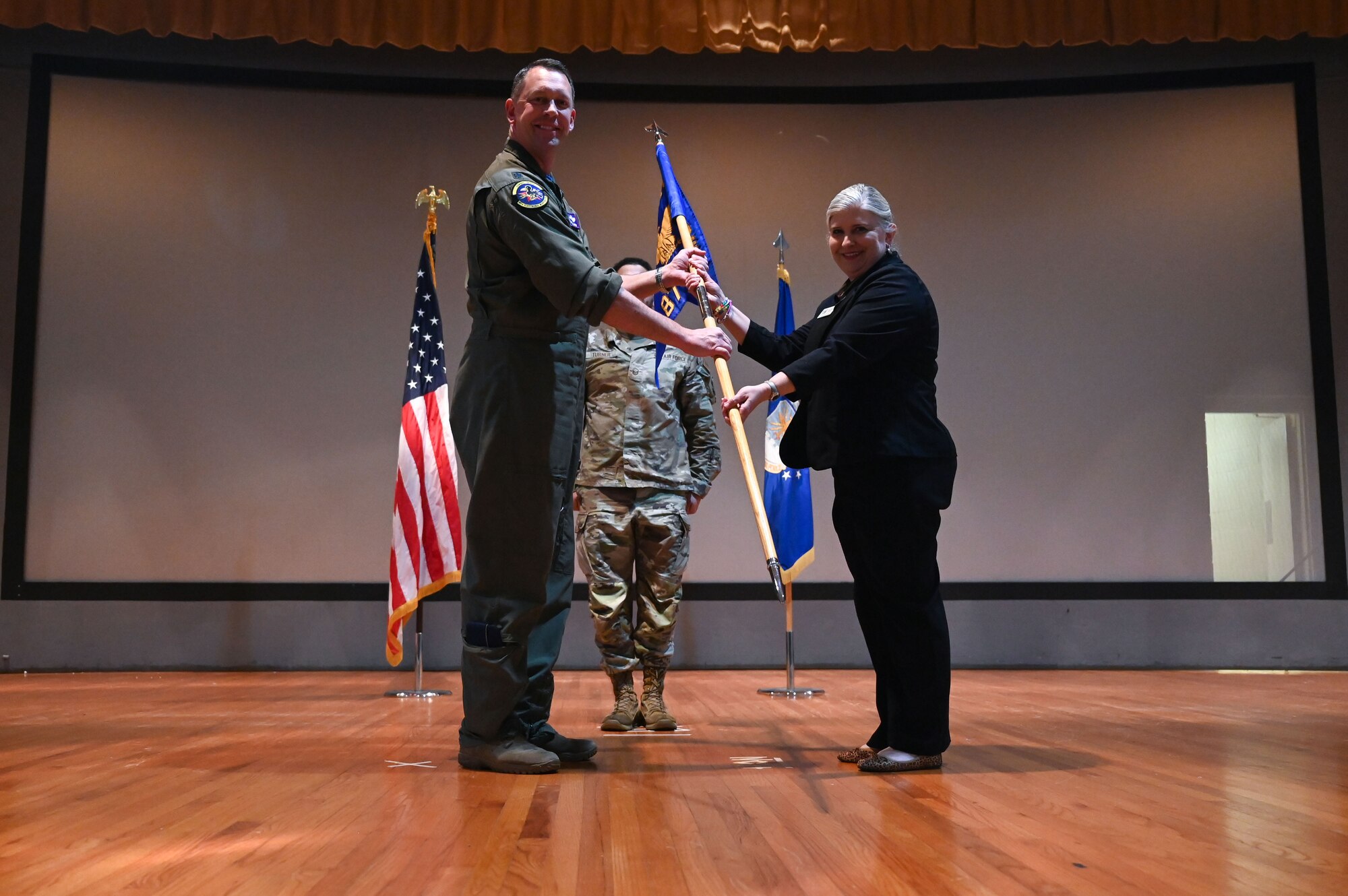 U.S. Air Force Lt. Col. Thomas Metzger, 87th Electronic Warfare Squadron commander, inducts Amy Klugh, the Bluewater Elementary Principal in Niceville and serves on the Niceville and Valparaiso Chamber of Commerce, during the wing’s first Honorary Commander Induction ceremony, at Eglin Air Force Base, Fla., Dec. 1, 2023. Honorary Commanders serve as the liaison between the 350th Spectrum Warfare Wing and the surrounding community by maintaining strong relations through mutually beneficial professional partnership. (U.S. Air Force photo by Staff Sgt. Ericka A. Woolever)