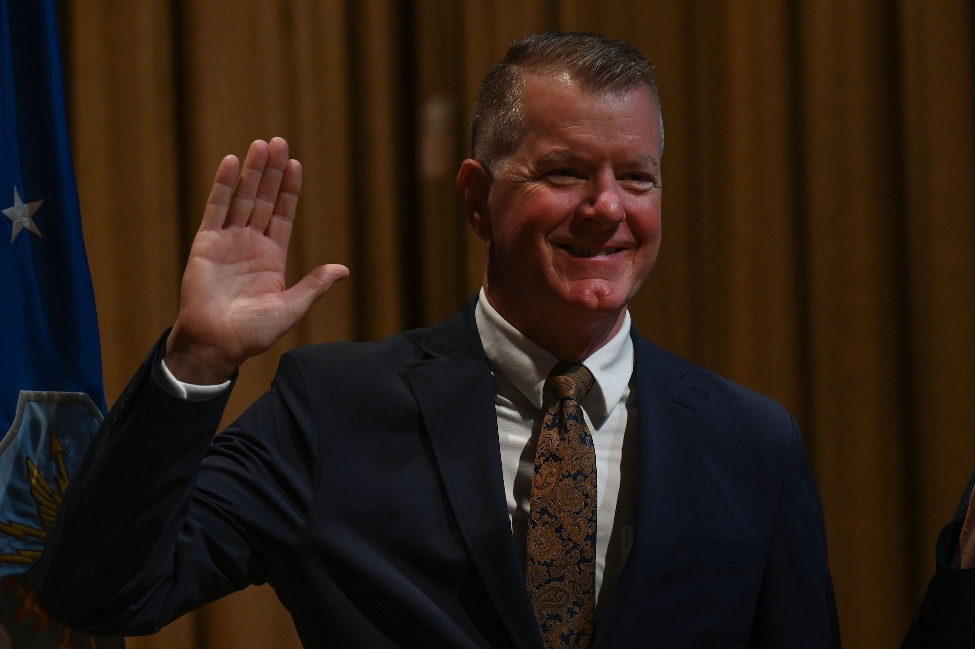 Tim Mccool, retired U.S. Air Force Lieutenant Colonel, founder and co-owner of 3rd Planet Brewery in Niceville, member of the Niceville Chamber of Commerce and the Northwest Florida State College Foundation Board, states the Oath of the Honorary Commander during the wing’s first Honorary Commander Induction ceremony, at Eglin Air Force Base, Fla., Dec. 1, 2023. The mission of the 350th Spectrum Warfare Wing Honorary Commanders Program is to educate key community leaders about a unit’s mission and to foster a supportive relationship with the community, while also increasing military involvement in civic endeavors and organizations. (U.S. Air Force photo by Staff Sgt. Ericka A. Woolever)