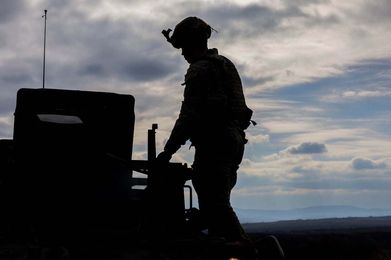 A soldier shown in silhouette.