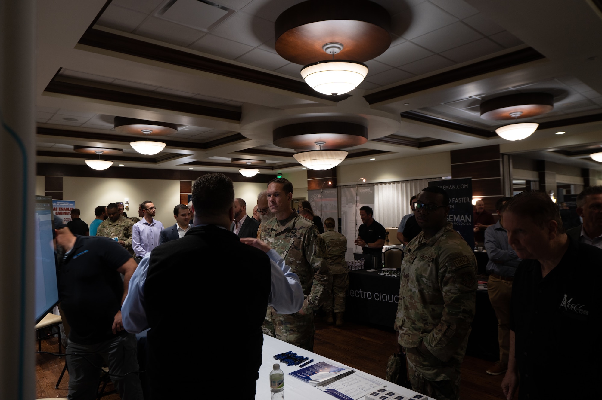 Service members and technology industry professionals discuss new innovations during a tech expo at MacDill Air Force Base, Florida, Dec 5, 2023.
