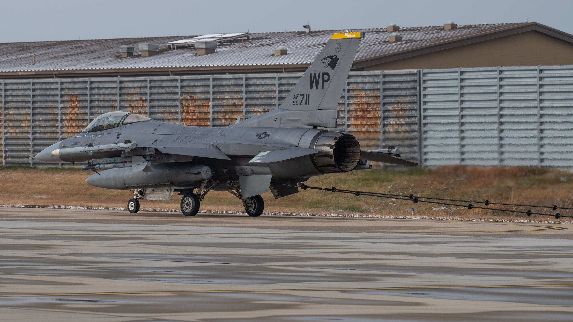 F-16 Fighting Falcon assigned to the 80th Fighter Squadron hooks an arresting cable during a certification test at Kunsan Air Base