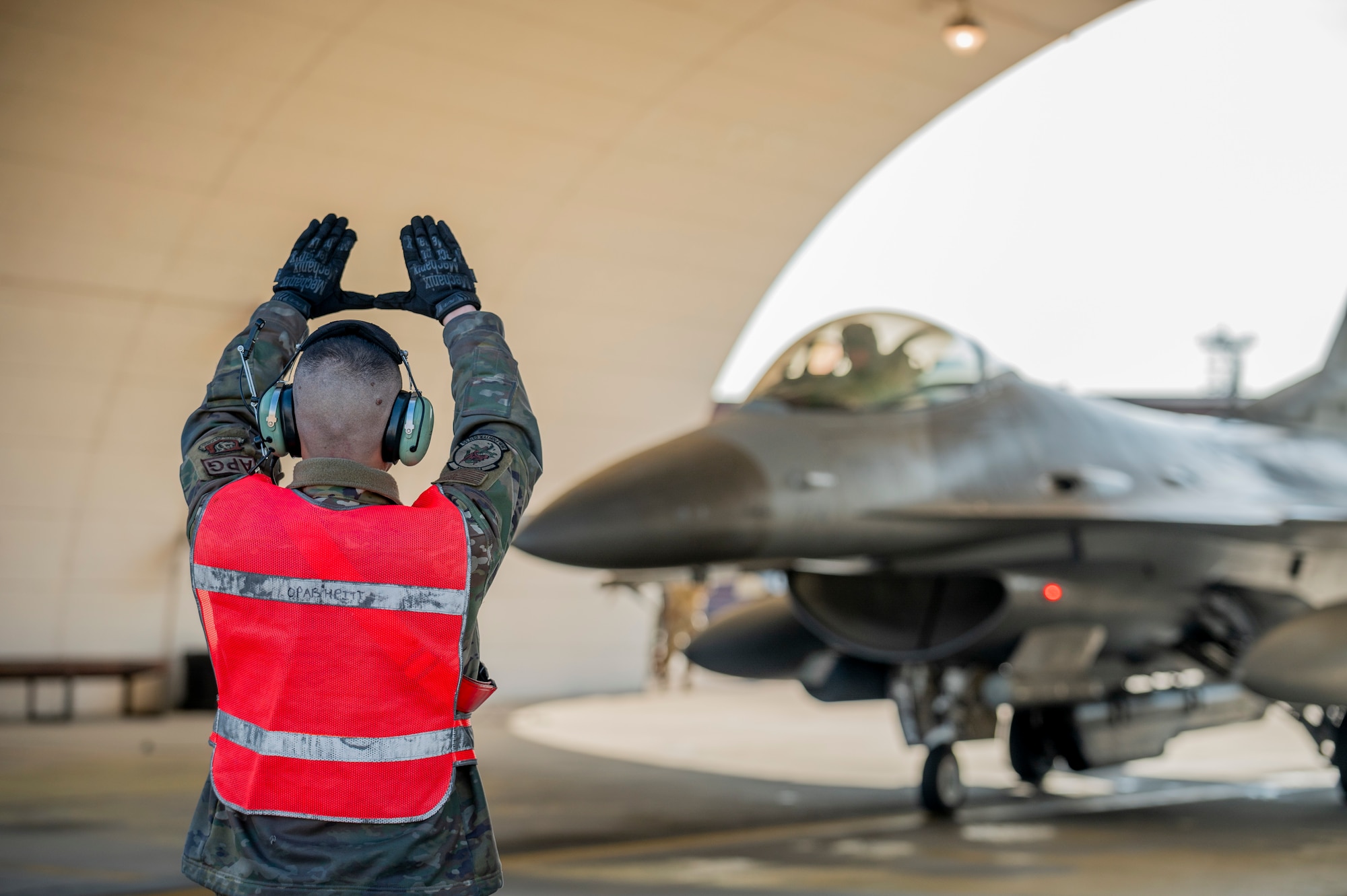 U.S. Air Force Senior Airman Jacob Wood, 36th Fighter Generation Squadron crew chief, guides an F-16 Fighting Falcon into a hot-pit refueling bay at Osan Air Base, Republic of Korea, Nov. 29, 2023.