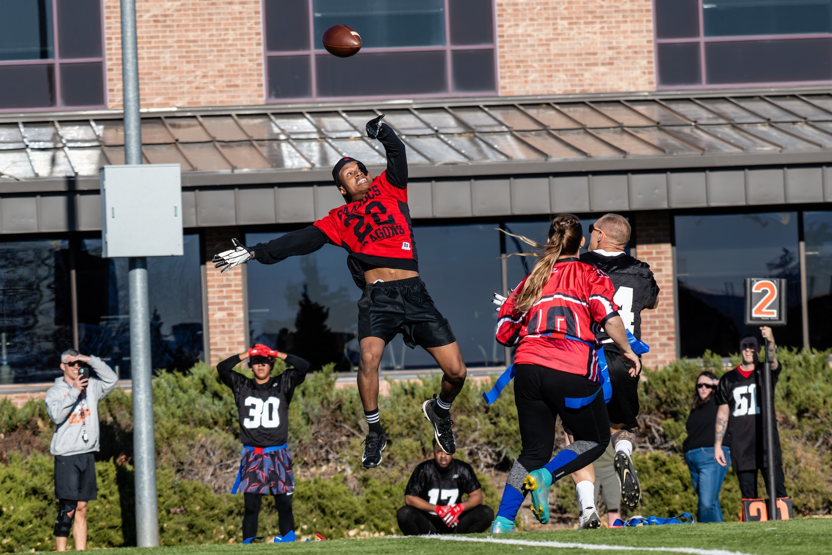 Man jumping in air to catch football