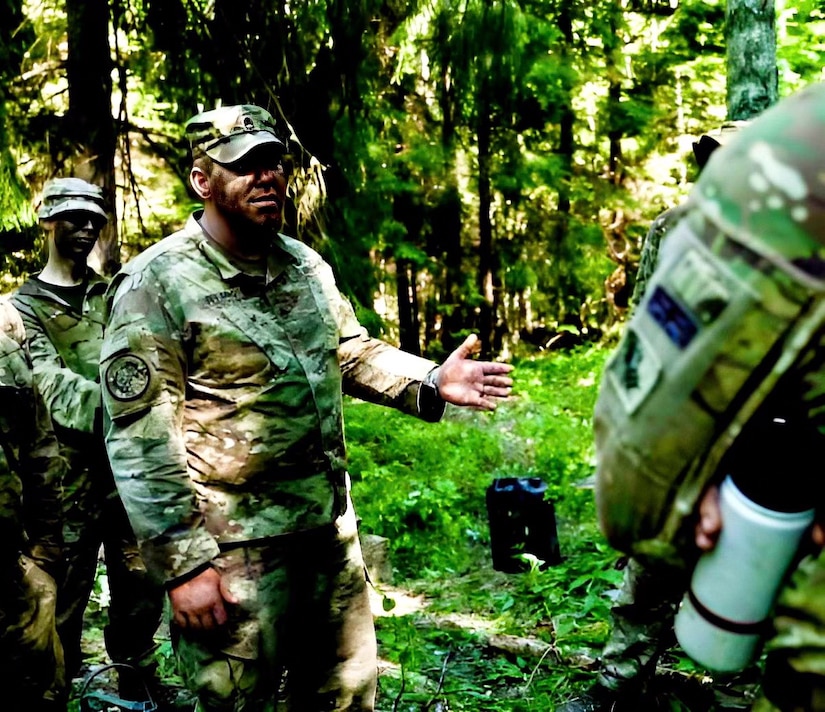 U.S. Army National Guard Staff Sgt. Peter Fleming (left) talks with service members of the United Kingdom's 7th Rifle Regiment during Operation Baltic Fist in Tapa, Estonia between June 27 and July 17, 2023. Operation Baltic Fist is part of the Department of Defense's Military Reserves Exchange Program in which U.S. reserve forces train with joint NATO partners to share tactics and procedures in different joint environments. (U.S. Army National Guard photo courtesy of Staff Sgt. Peter Fleming)