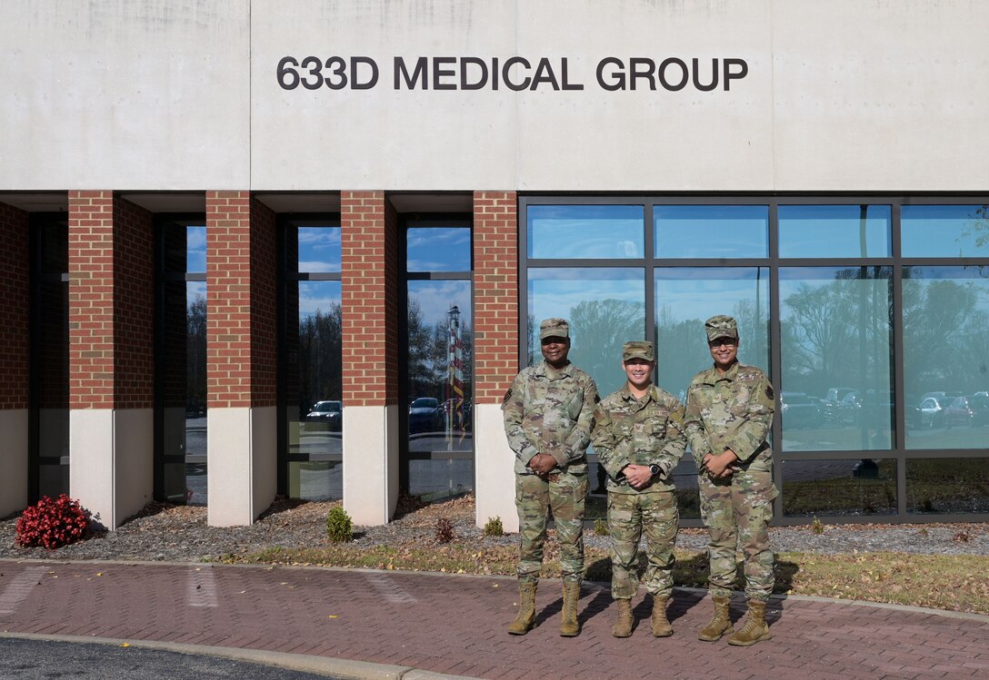 From left, U.S. Air Force Staff Sgt. Melissa Smith, 633d Operational Medical Readiness Squadron nutritional medicine non-commissioned officer in charge, Senior Airman Jessi Wilson, 633d ORMS diet technician, and Tech Sgt. Kirk Luzano, 633d OMRS flight chief stand outside of the hospital at Joint Base Langley-Eustis, Virginia, Nov. 28, 2023. The three Airmen run the nutritional medicine clinic and help their patients develop diet and weight management plans to help them manage a diet plan to stay mission ready. (U.S. Air Force photo by Airman 1st Class Adisen Smith)