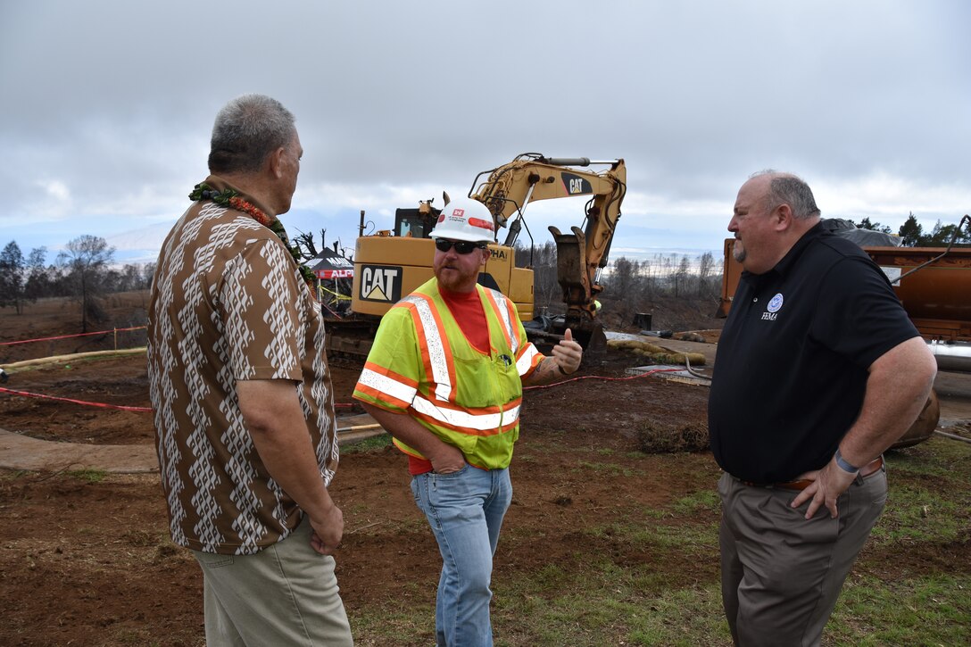 The U.S. Army Corps of Engineers were honored to have Maui Mayor Richard T. Bissen, Jr., and FEMA Region 9 Administrator Robert J. Fenton, Jr., as visitors to observe debris removal operations in Kula, Hawaiʻi, Nov. 28, 2023. Here Bissen, left, and Fenton, right, speak with Chris Poth, USACE Quality Assurance Supervisor, center, during their visit. USACE photos by Shannon Bauer.