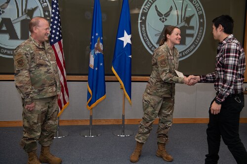 Colonel congratulates graduate.