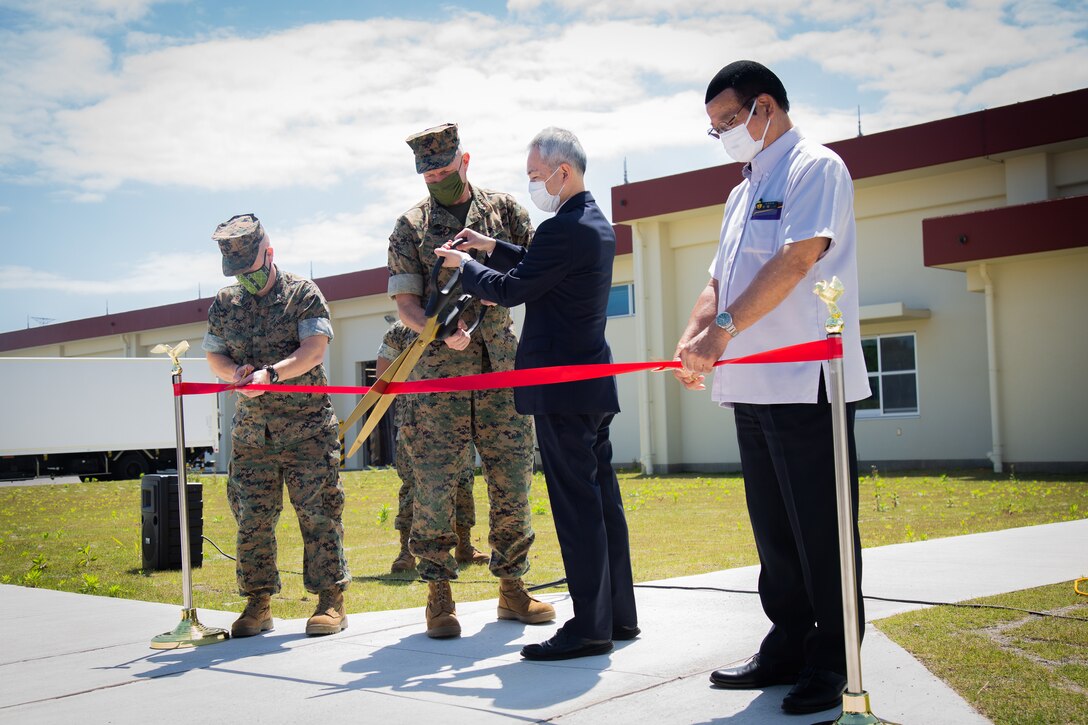 From left, U.S. Marine Corps Col. Lester R. Gerber, commanding officer of III Marine Expeditionary Force Information Group, Maj. Gen. William J. Bowers, commanding general of Marine Corps Installations Pacific, Isao Ono, director general of Okinawa Defense Bureau, and Mayor Hajime Nakama, mayor of Kin Town, Okinawa Prefecture, cut the ribbon during a ribbon-cutting for the Cook-Chill facility at Camp Hansen, Okinawa, Japan, on April 6, 2022. The ceremony recognized the movement from Camp Kinser to Camp Hansen and those who participated in the planning, execution, and construction process. It also showcased the importance of future developments of projects under the Defense Policy Review Initiative as part of the land redevelopment, including returns to the Government of Japan from the U.S. forces. (U.S. Marine Corps photo by Sgt. Kayla V. Staten)