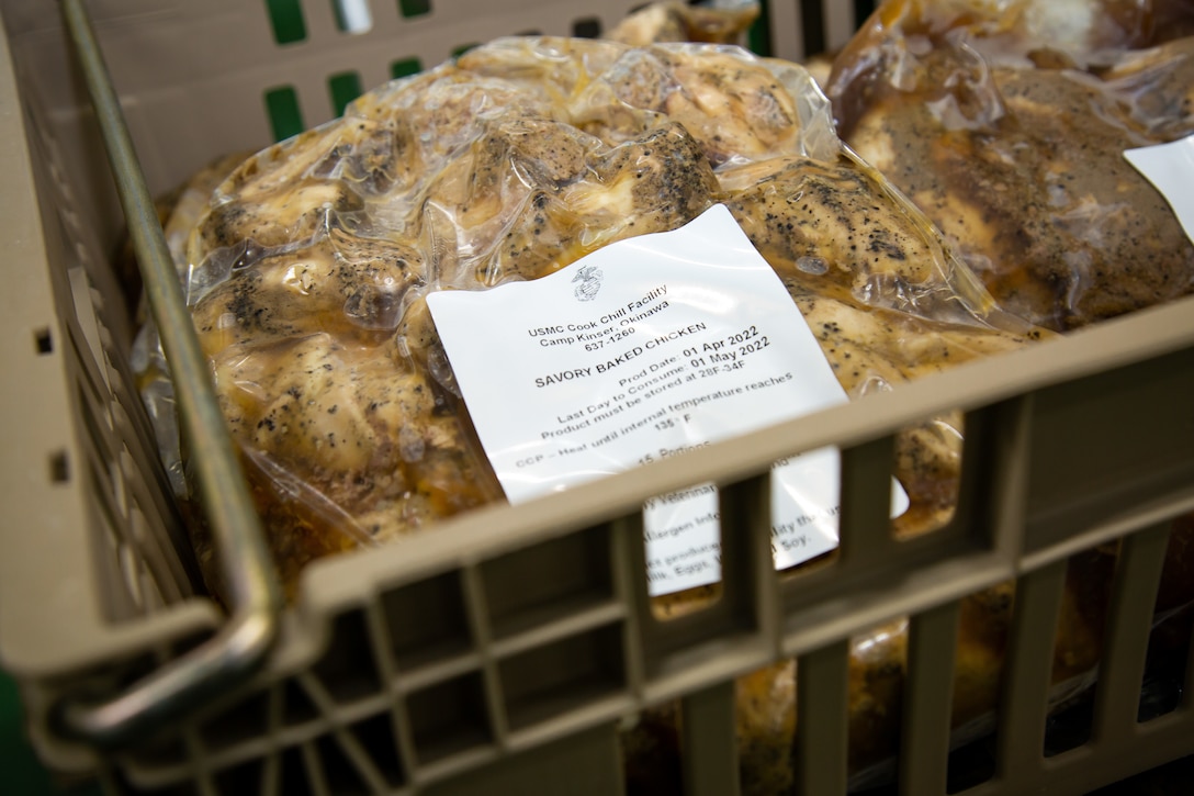Packages of savory baked chicken is displayed during a tour of the Cook-Chill facility after a ribbon-cutting ceremony at Camp Hansen, Okinawa, Japan, on April 6, 2022. The ceremony recognized the movement from Camp Kinser to Camp Hansen and those who participated in the planning, execution, and construction process. It also showcased the importance of future developments of projects under the Defense Policy Review Initiative as part of the land redevelopment, including returns to the Government of Japan from the U.S. forces. (U.S. Marine Corps photo by Sgt. Kayla V. Staten)