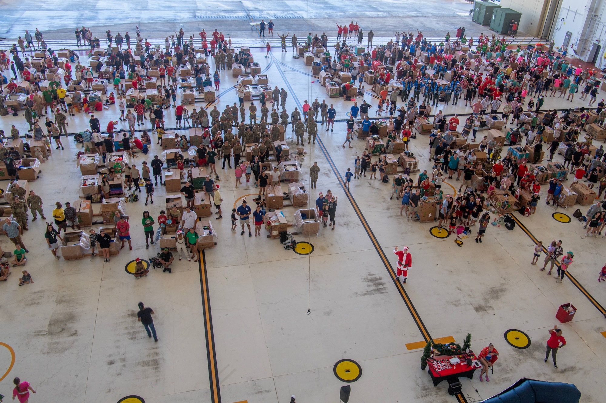 Photo of U.S., Allies and partners, and volunteers building bundles for Operation Christmas Drop