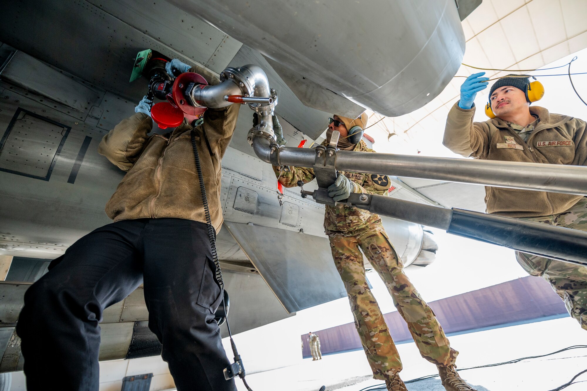 Hutchinson, 36th Fighter Generation Squadron crew chief, U.S. Army Spc. Marcus Grant, 2nd Infantry Division Sustainment Brigade petroleum supply specialist, and U.S. Air Force Staff Sgt. Antonio Rios, 51st Logistics Readiness Squadron fuels distribution supervisor, perform a hot-pit refuel on an F-16 Fighting Falcon during a joint training event at Osan Air Base, Republic of Korea, Nov. 29, 2023.