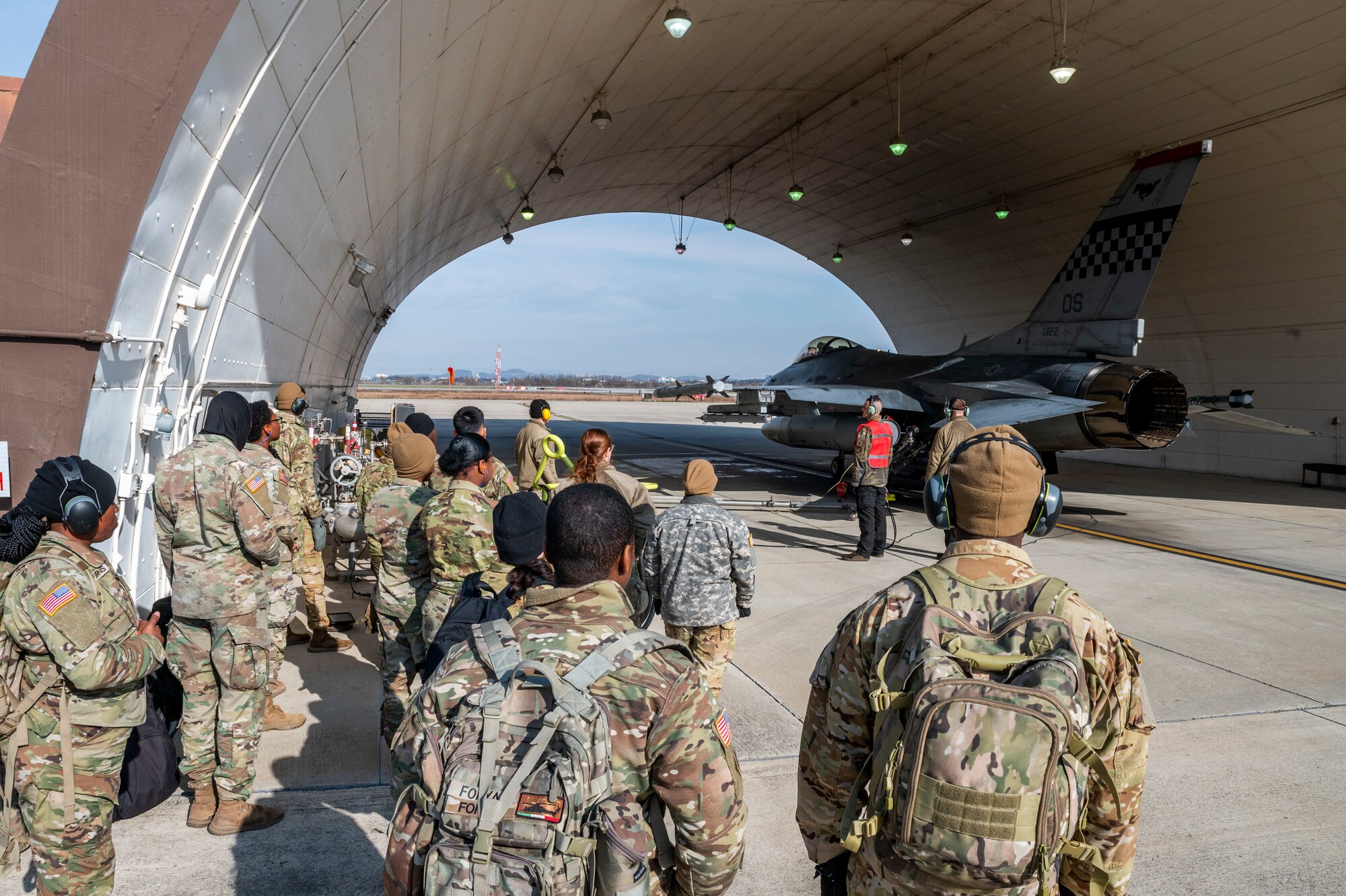 U.S. Army Soldiers, 2nd Infantry Division Sustainment Brigade, observe an F-16 Fighting Falcon hot-pit refueling with the 51st Logistics Readiness Squadron fuels flight at Osan Air Base, Republic of Korea, Nov. 29, 2023.