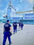 A U.S. Coast Guard Sector Boarding Team, a key component of U.S. Coast Guard Forces Micronesia/Sector Guam, conducts a thorough security boarding of the 380-foot (116-meter) motor vessel Papa Mau, flagged from Antigua Barbuda, at the Port of Guam on Dec. 6, 2023. This general cargo vessel, arriving from Pohnpei in the Federated States of Micronesia (FSM), was meticulously inspected upon reaching Guam and found to be in full compliance. (U.S. Coast Guard photo by Lt. Brian Maffucci)