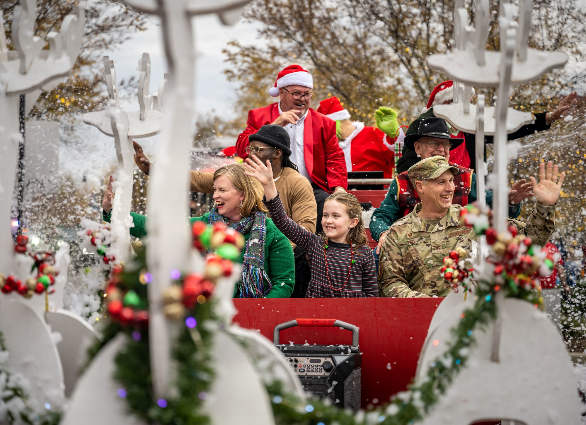 U.S. Air Force Col. Lucas Teel, 4th Fighter Wing commander, his wife, Meghan Teel and daughter, Annie Teel, ride in a parade float as part of a holiday parade in downtown Goldsboro, North Carolina, Dec. 2, 2023. The 4th FW Airmen celebrate the holidays with the community building trust and fostering support. (U.S. Air Force photo by Senior Airman Sabrina Fuller-Judd)