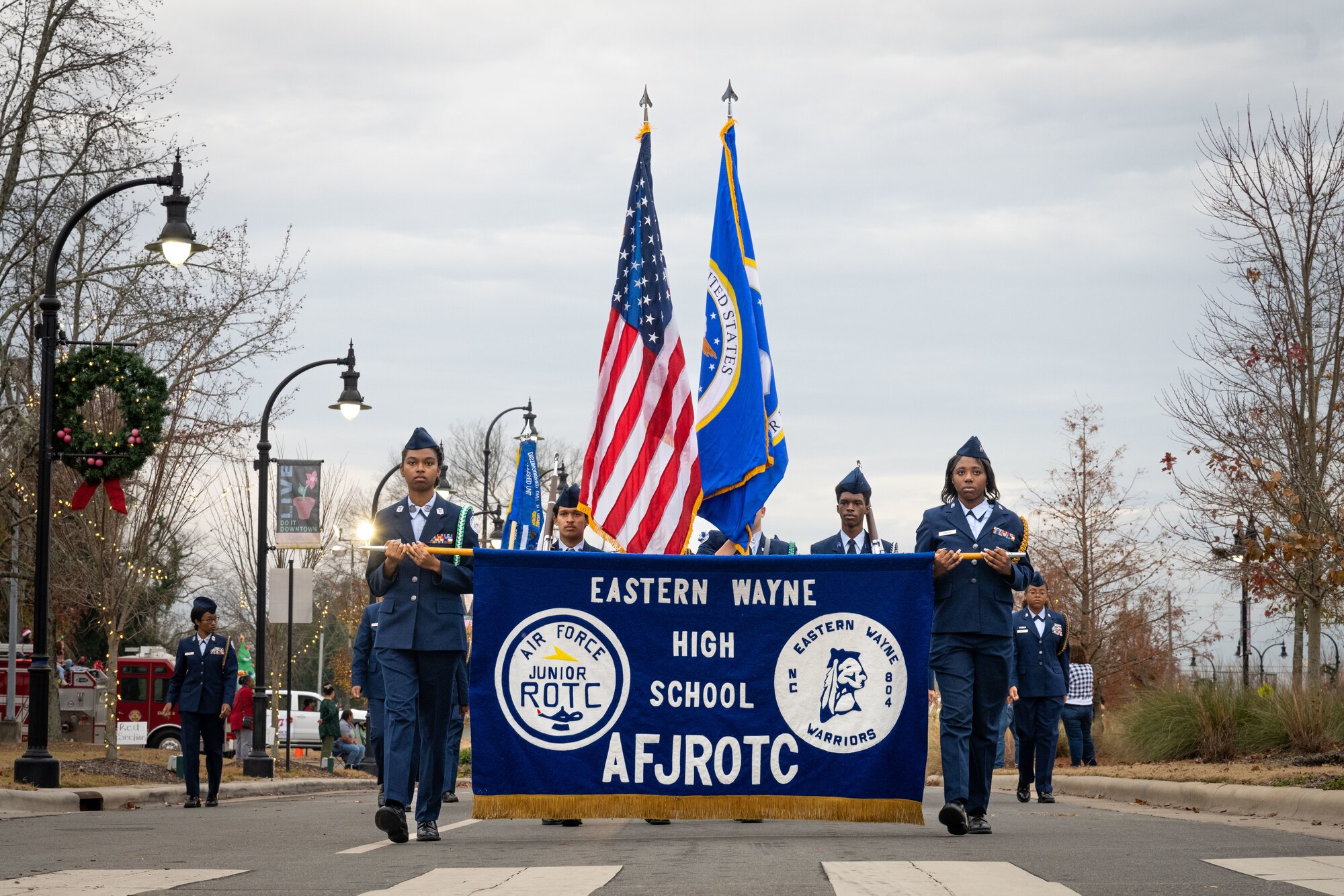 Members of the Eastern Wayne High School Air Force JROTC program join the holiday parade, in downtown Goldsboro, North Carolina, Dec. 2, 2023. The holiday parade was joined by several schools, community agencies, civic leaders and Seymour Johnson personnel. (U.S. Air Force photo by Senior Airman Sabrina Fuller)