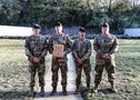 Multiple men in U.S. Army uniforms on outdoor range.