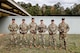 Multiple men in U.S. Army uniforms on outdoor range.