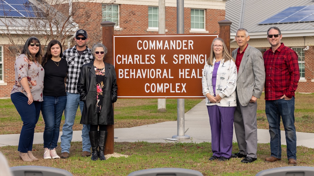 Family members of Cmdr. Charles K. Springle pose for a photo at the Commander Charles K. Springle Behavioral Health Complex building rededication ceremony at Midway Park on Marine Corps Base Camp Lejeune, North Carolina, Dec. 4, 2023. Springle was killed in Iraq in 2009 after serving 21 years in the U.S. Navy as a licensed clinical social worker. In his memory, the building honors his dedication to helping fellow service members. (U.S. Marine Corps photo by Lance Cpl. Alyssa J. Deputee)